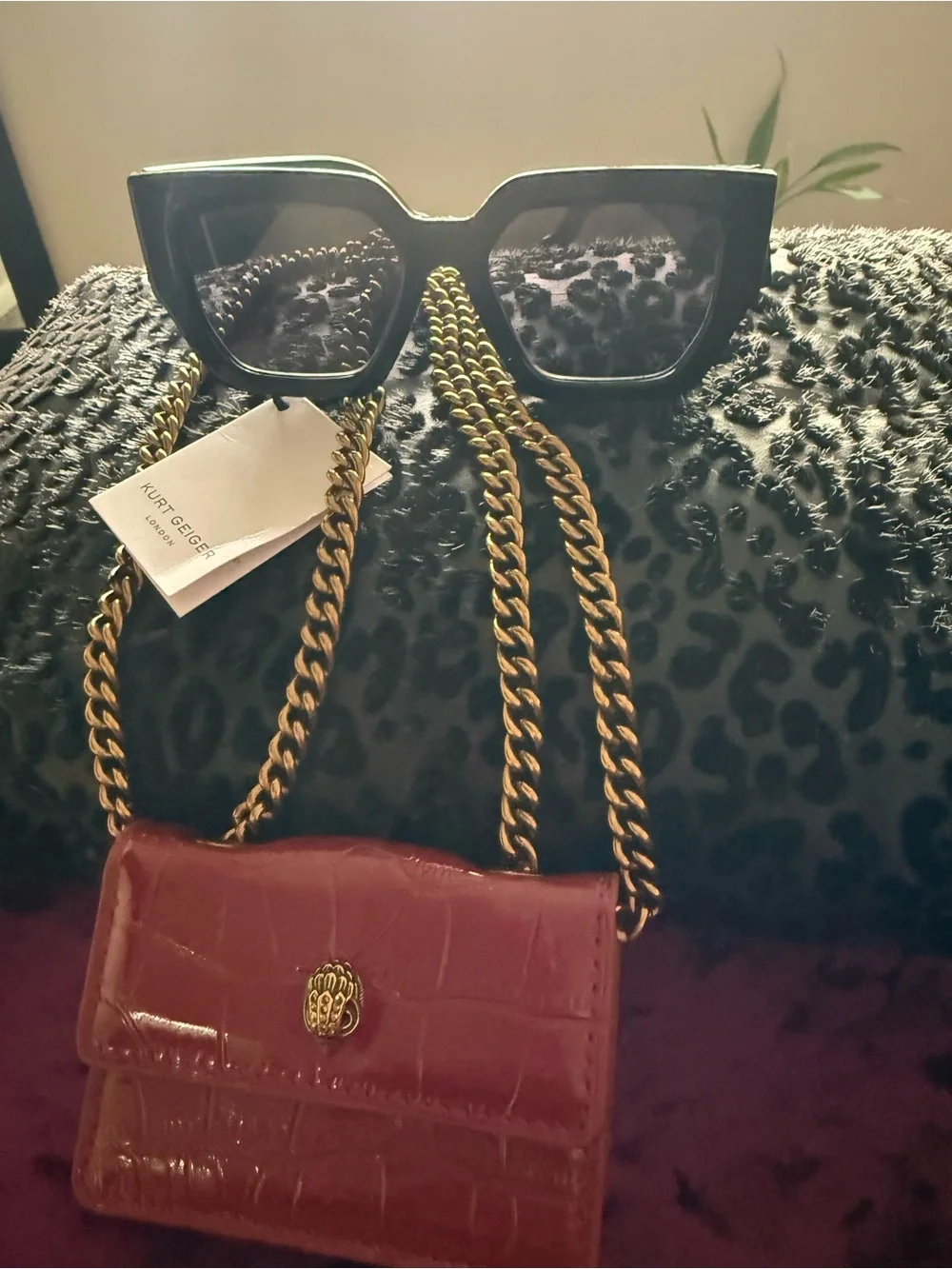 Kurt Geiger Glossy Croc-Effect Mini Crossbody with Gold Chain with sunglasses